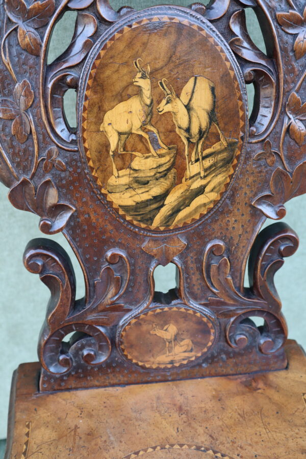 Late 19thC Swiss black forest walnut and marquetry hall chair.